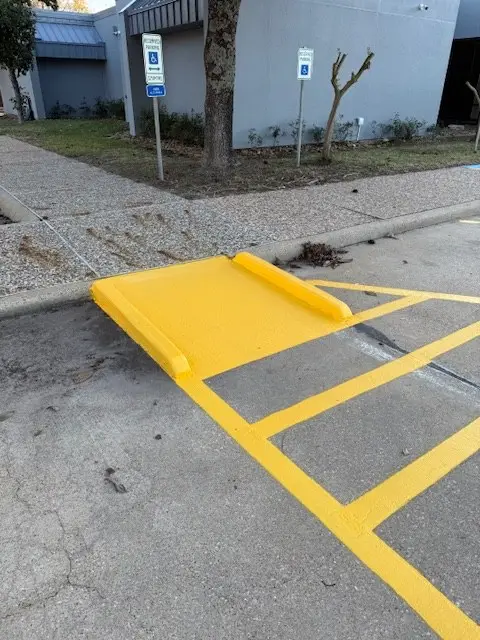 Accessible curb ramp painted with hatched access aisle