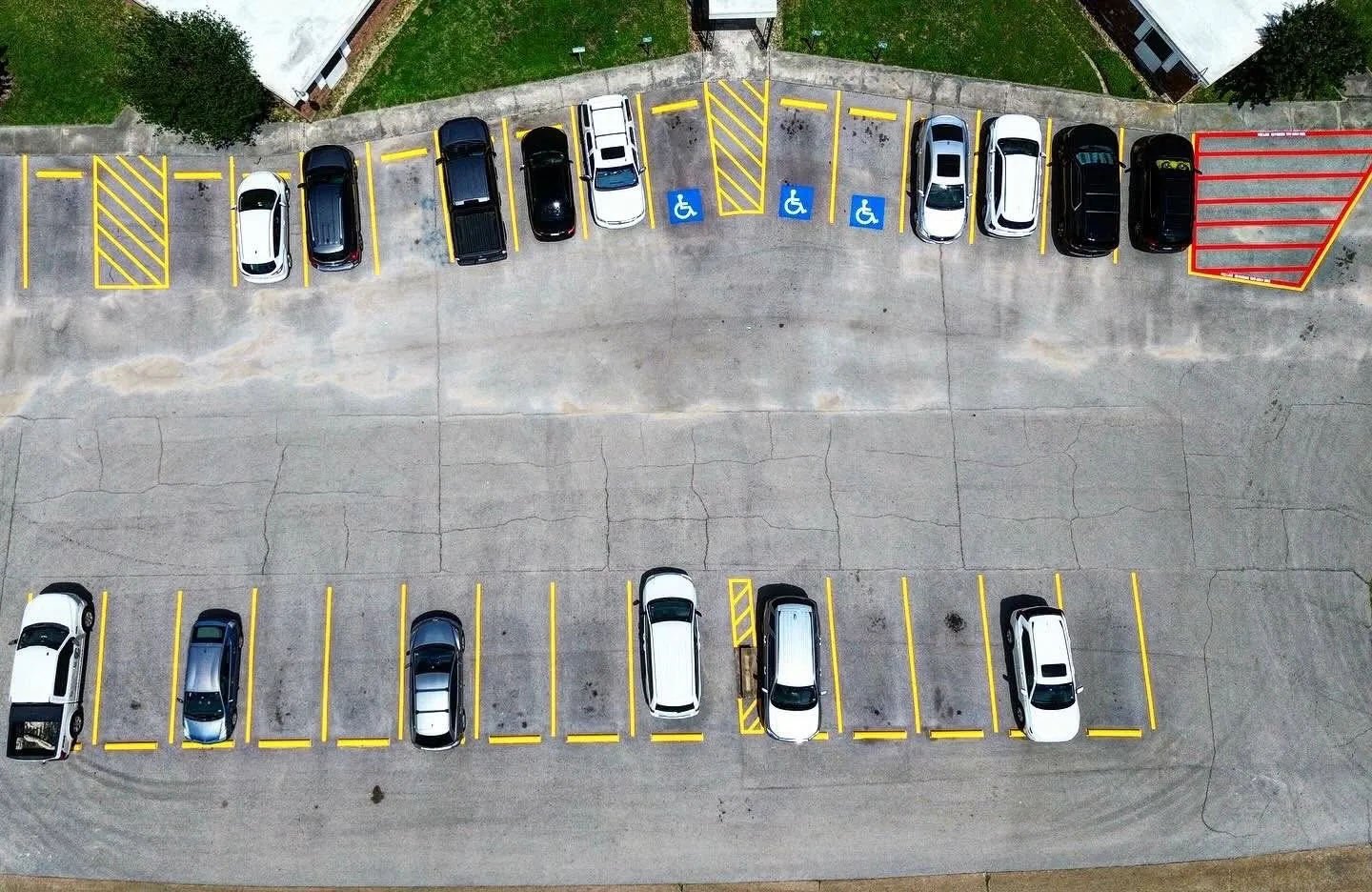 Aerial view of an apartment community lot with new stalls and accessible markings