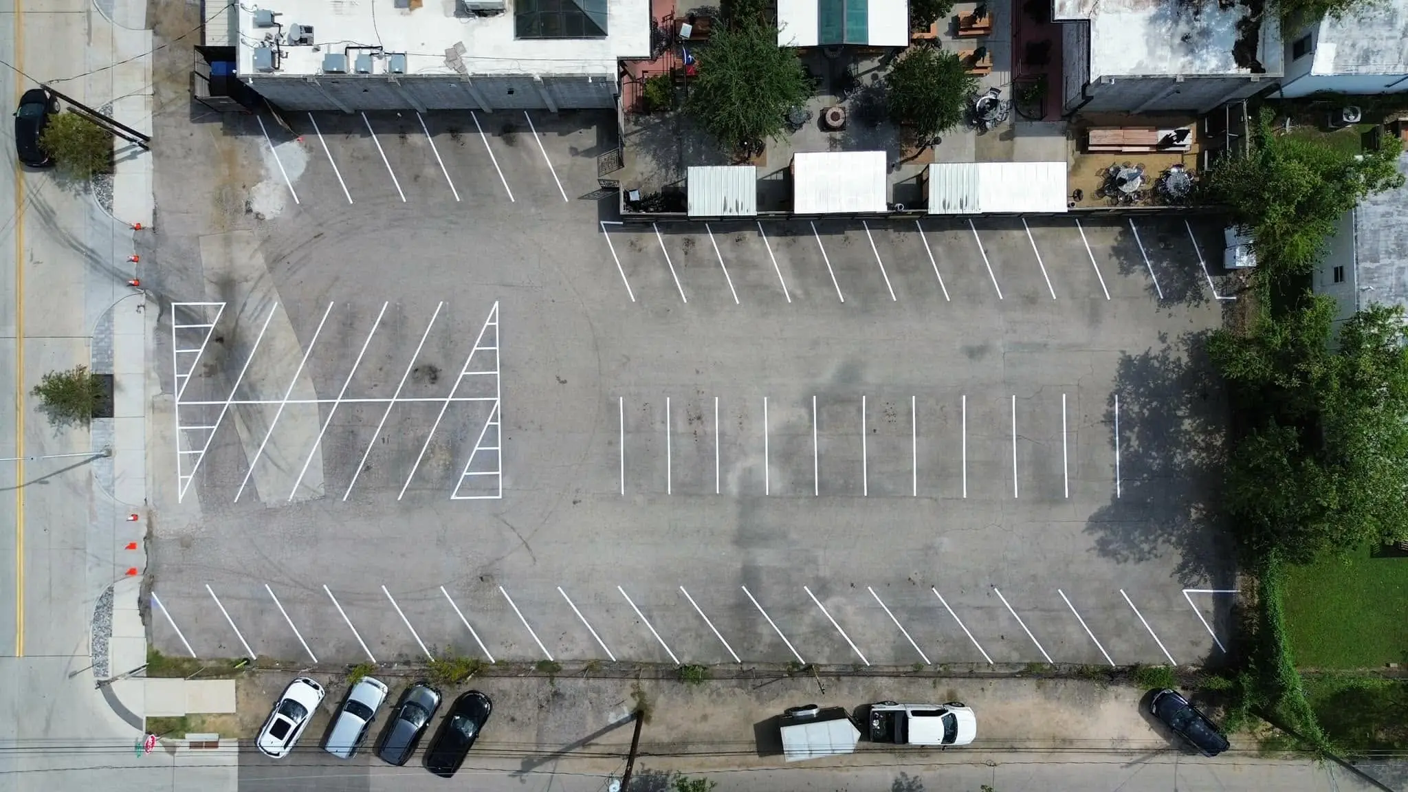 Re-striped commercial lot with white stalls and hatched island