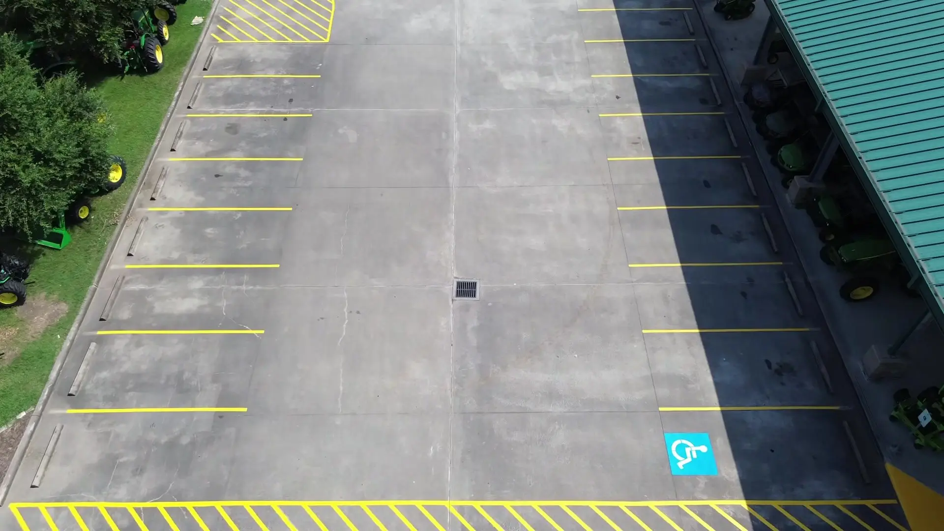 Dealership lot with wheel stops installed on every stall