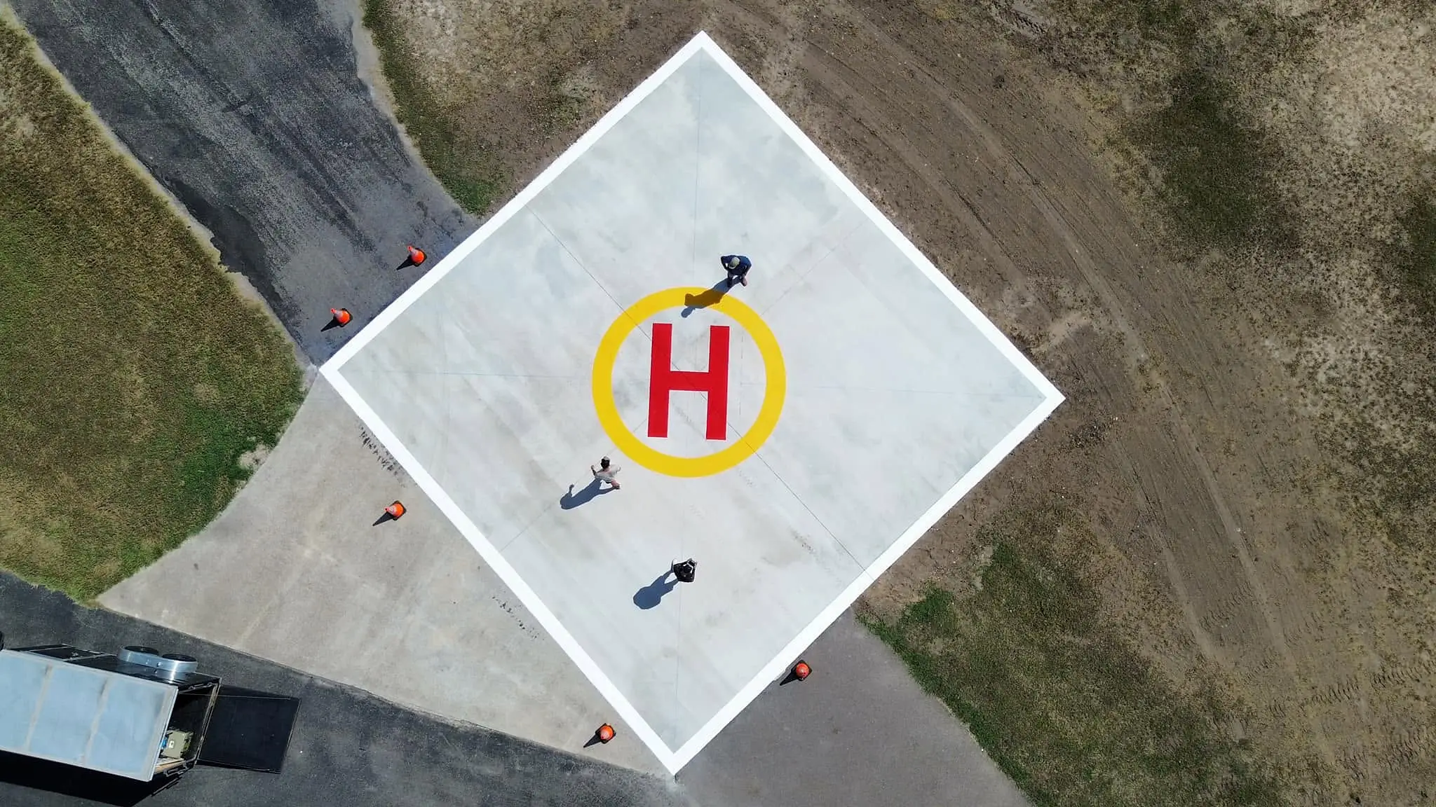 Overhead drone view of the crew completing the helipad markings