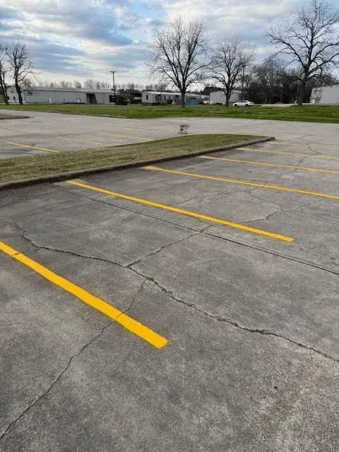 New yellow stripes over aged pavement