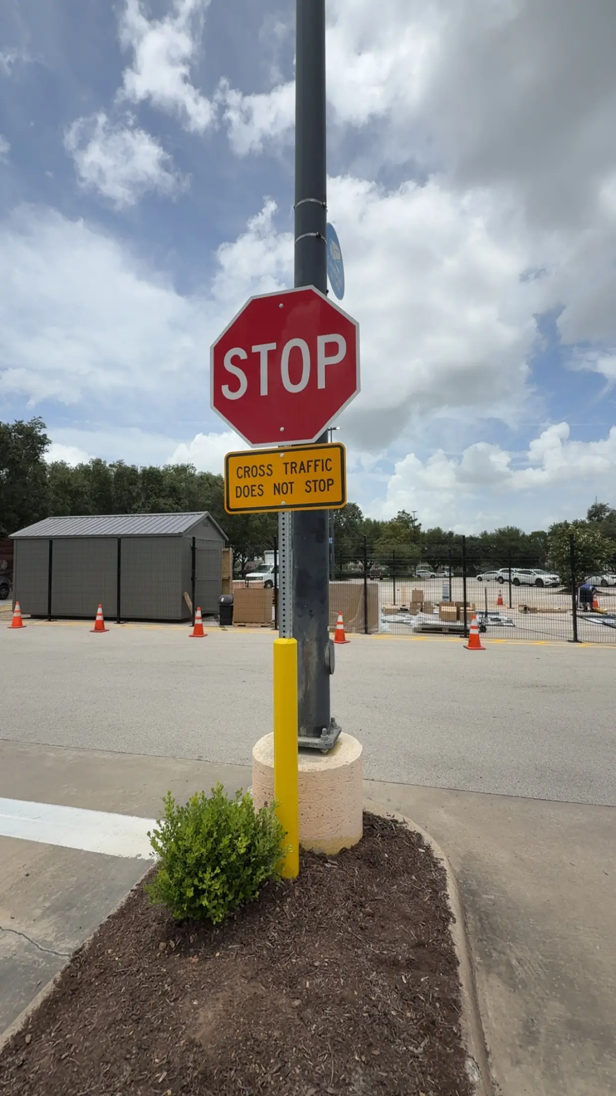 New STOP sign and cross-traffic placard at a lot exit