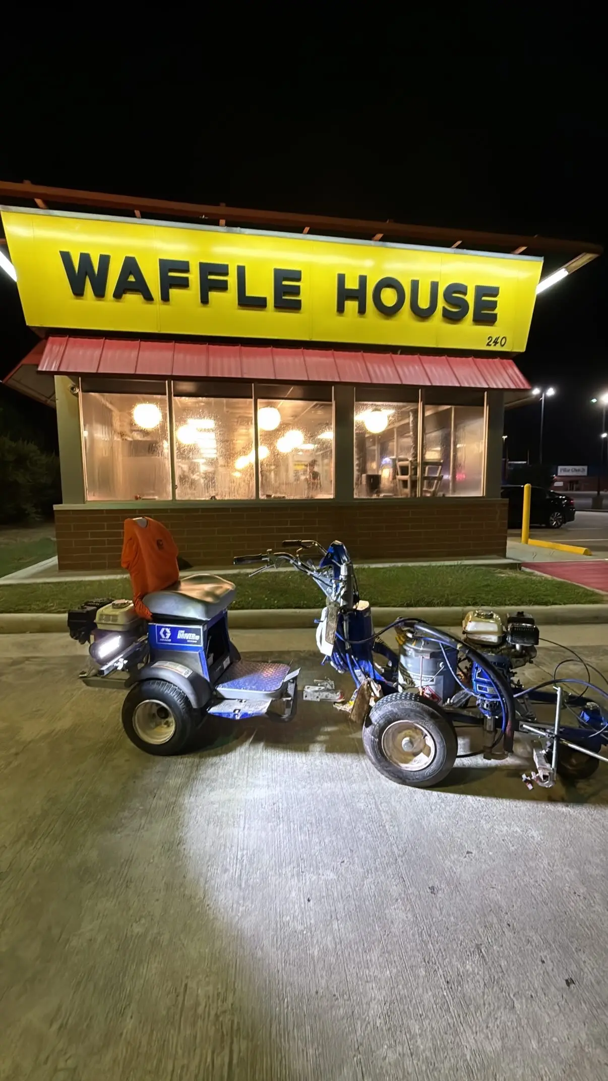 Line driver and striping rig staged at night