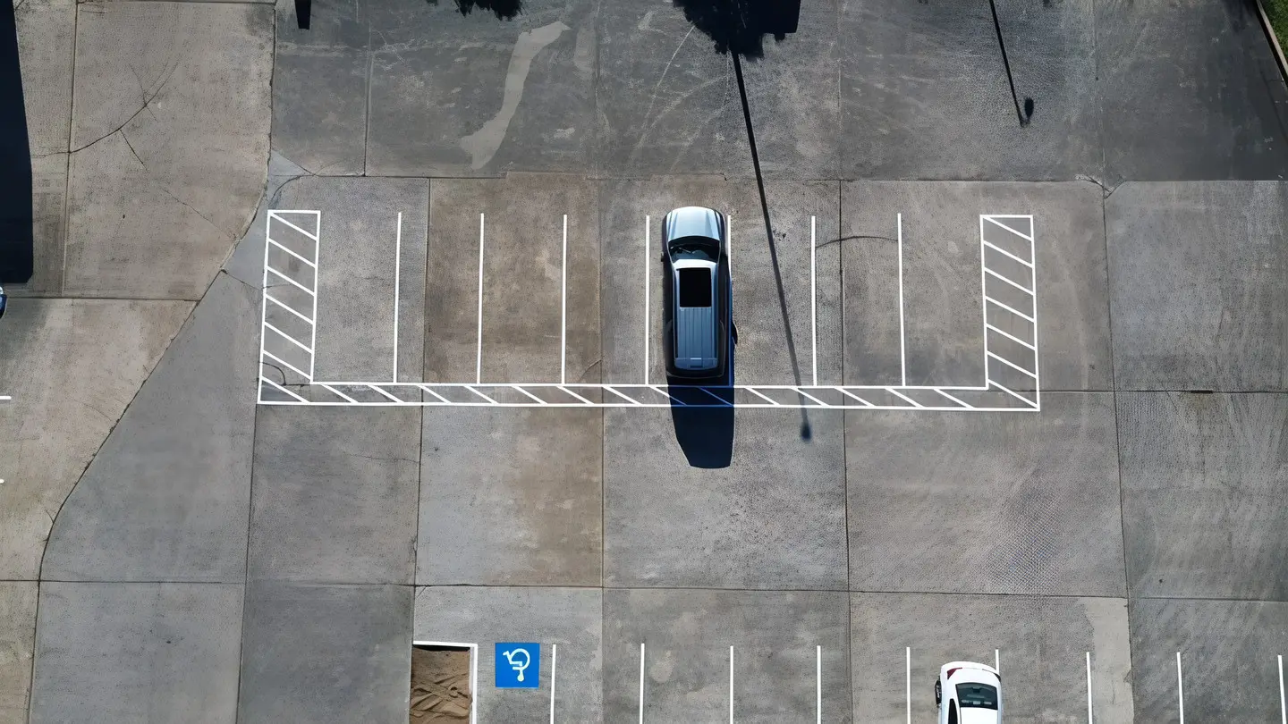 Aerial of new white stall lines across a commercial lot