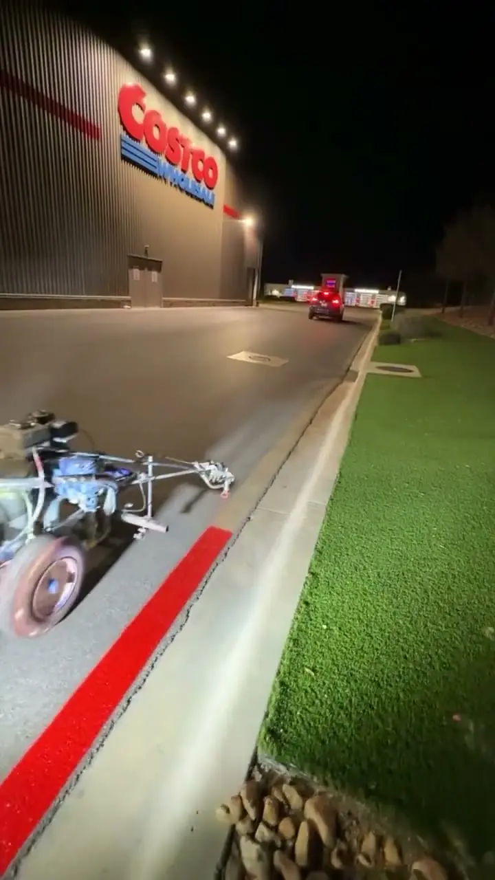 Fresh fire-lane red curb line at a big-box warehouse store at night